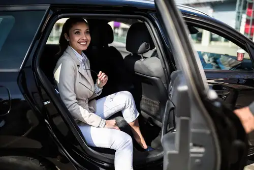 Elegant woman enjoying chauffeur service