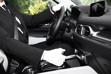 Side view of a chauffeur driving a luxury black limousine represents Lavish Ride’s Houston private limo service.