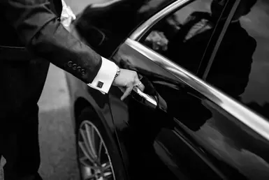 Hand on handle. Close-up of Private Chauffeur hand opening / close a car door, chauffeur car service background concept