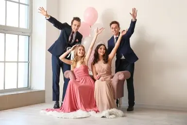 Two young men and two young women dressed in elegant prom outfits, smiling and posing together before heading to their prom night — symbolizing Lavish Ride’s prom limo service in Houston.