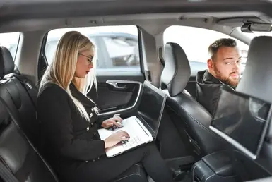 Houston executive car service for corporate travel with business professional working in luxury chauffeur vehicle