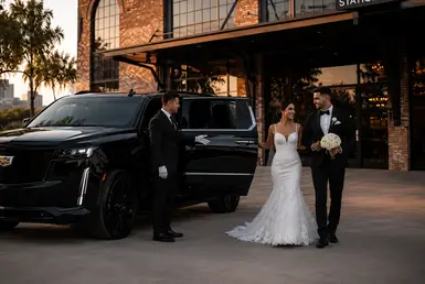 Bride and groom arriving at Station 3 Houston in a black Cadillac Escalade with Houston wedding professional chauffeur service