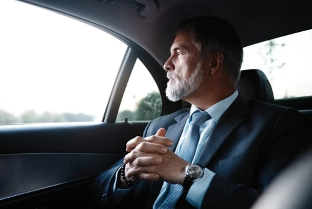 Mature businessman in luxury car, comfortable transportation for seniors.