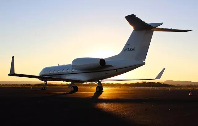 A Gulfstream G550 private jet on the airport runway, beginning its takeoff roll, symbolizes luxury private jet and car service in Houston.